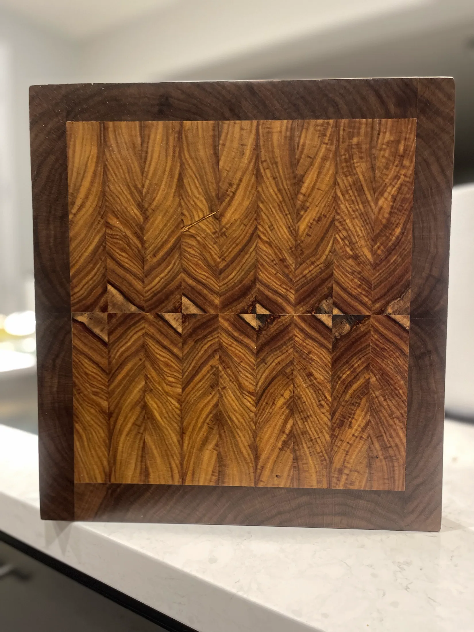 Chevron-pattern canary wood and walnut pasta board