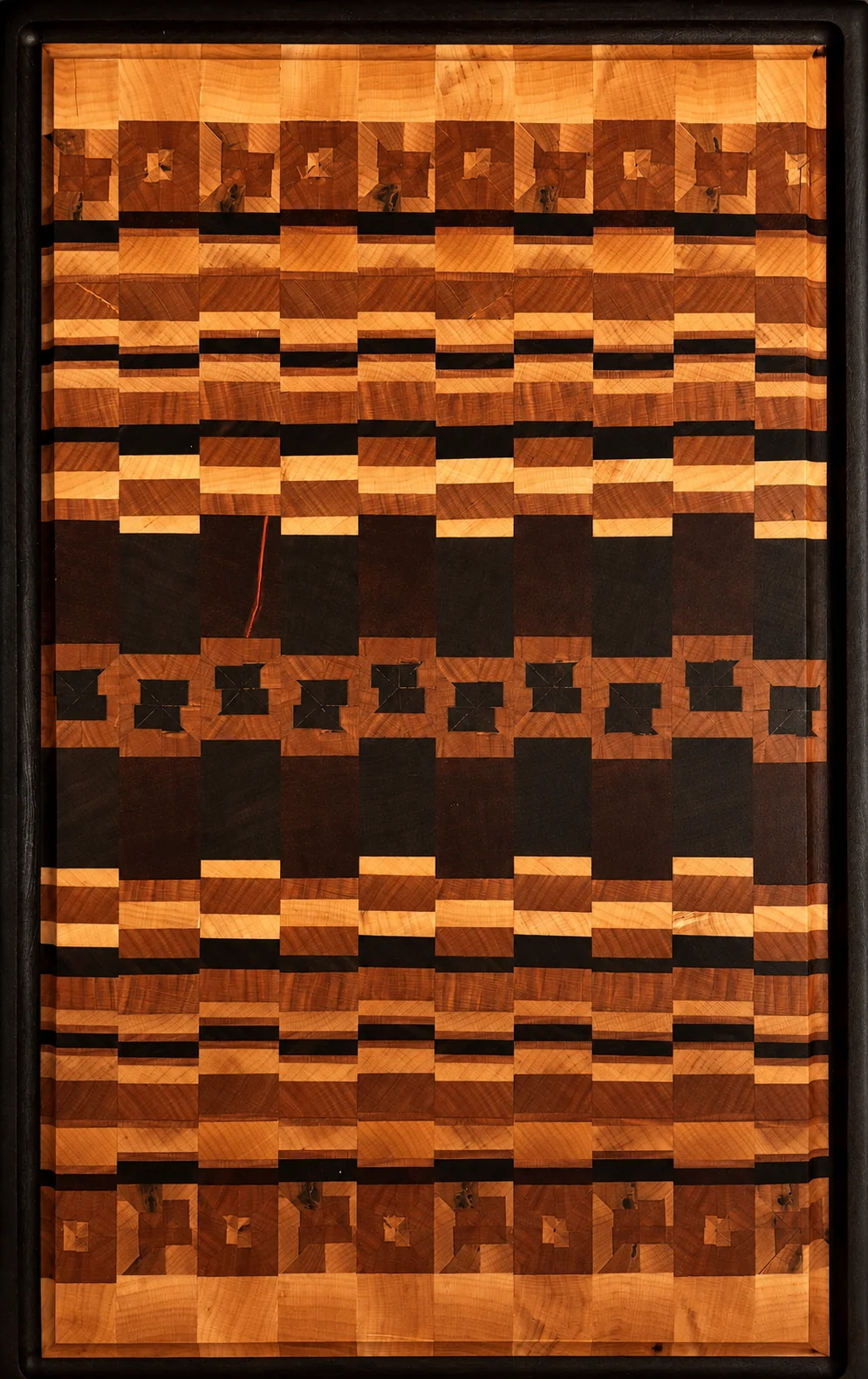 Tall portrait of a complex light-and-dark geometric cutting board