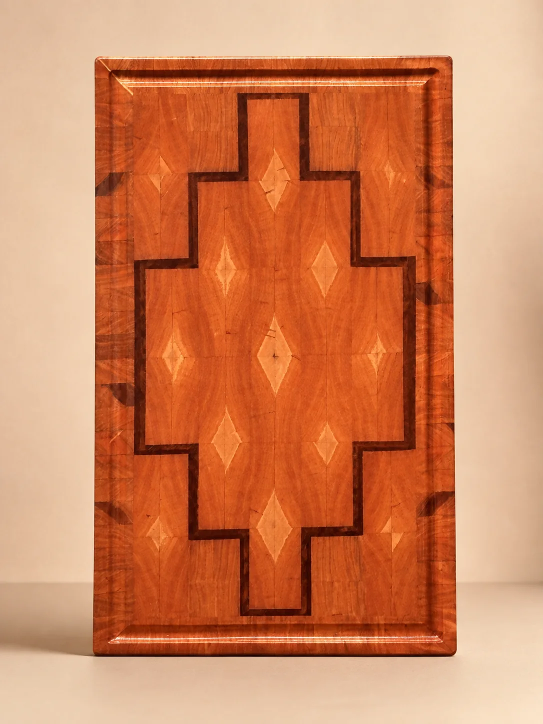 Long rectangular hardwood board with a stepped dark inlay and light diamond accents