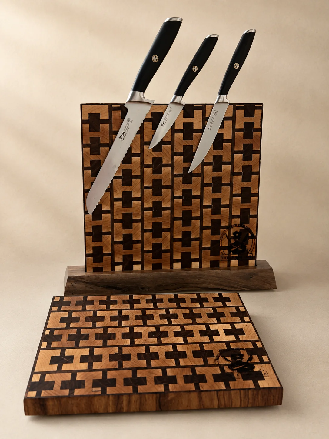 Matching geometric magnetic knife holder and cutting board displayed with three knives