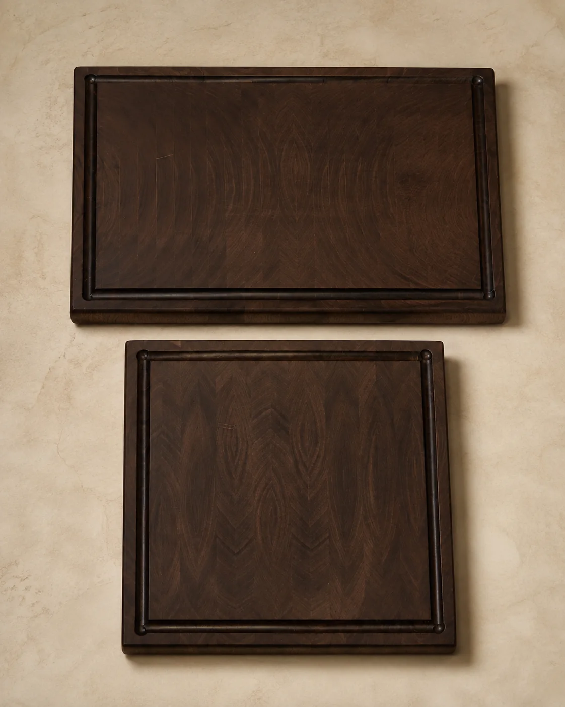 Two matching walnut boards with carved perimeter grooves